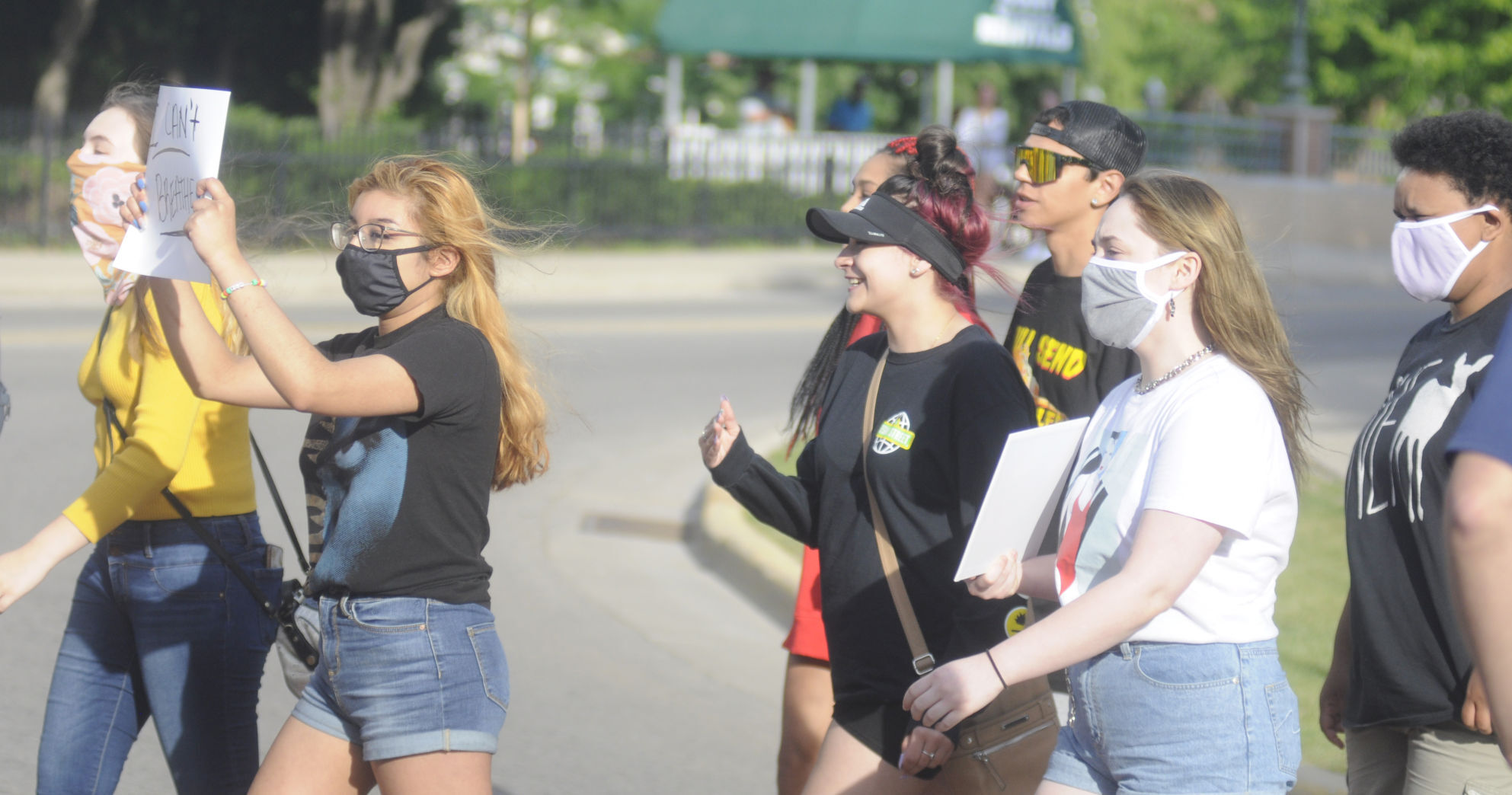 Demonstrators march across Wrigley Drive